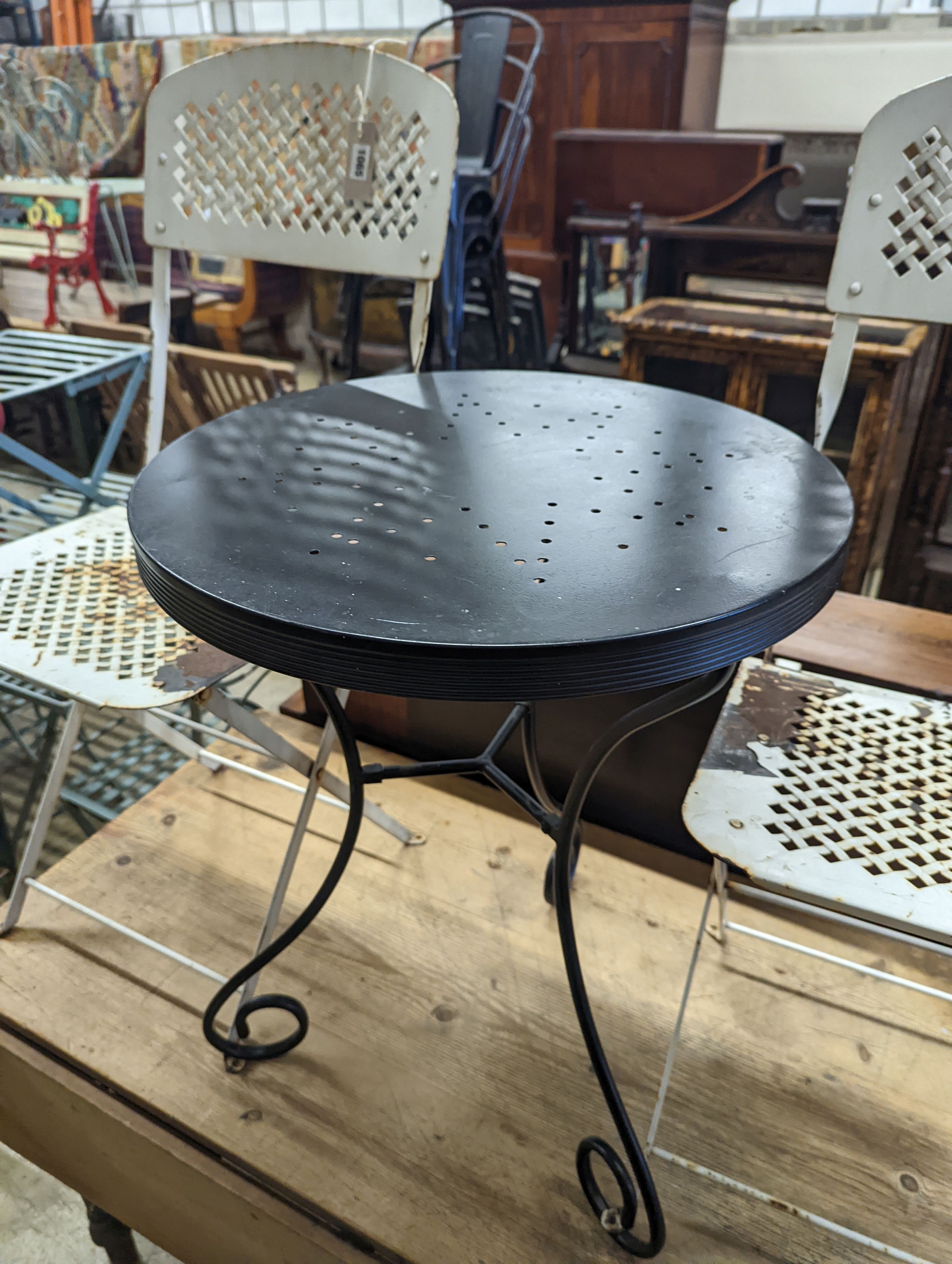 A circular metal bistro table, diameter 49cm, height 65cm and two chairs